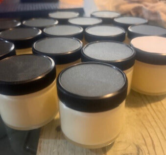 Breathe easy jars with black lids on a wooden surface
